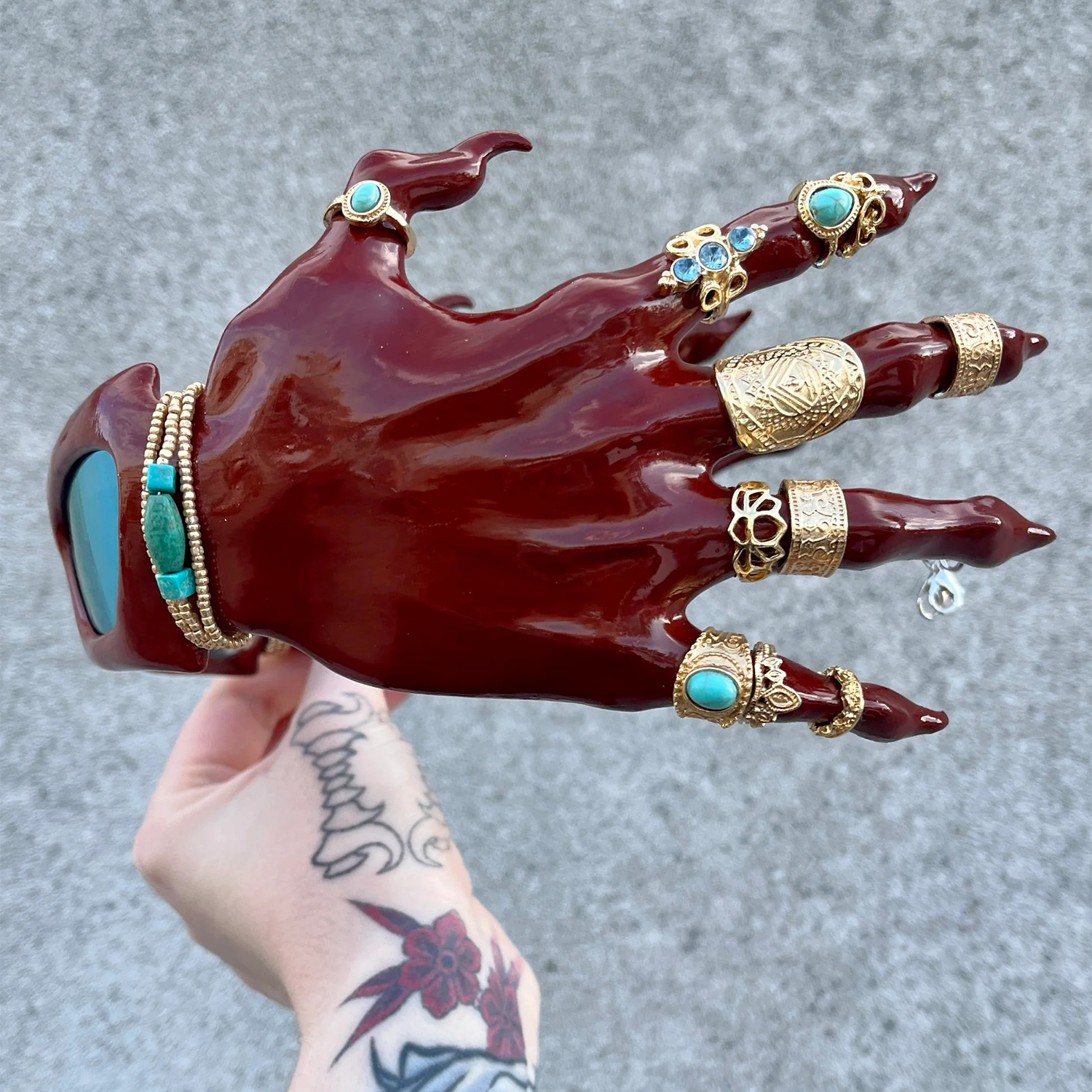3D-printed red hand-shaped sunglasses