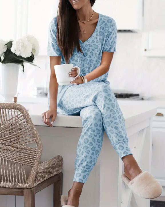 Women's V-NeckLeopard Print Loungewear Set. This relaxed-fit two-piece features a short-sleeve top and pants for effortlessly chic, casual comfort.
