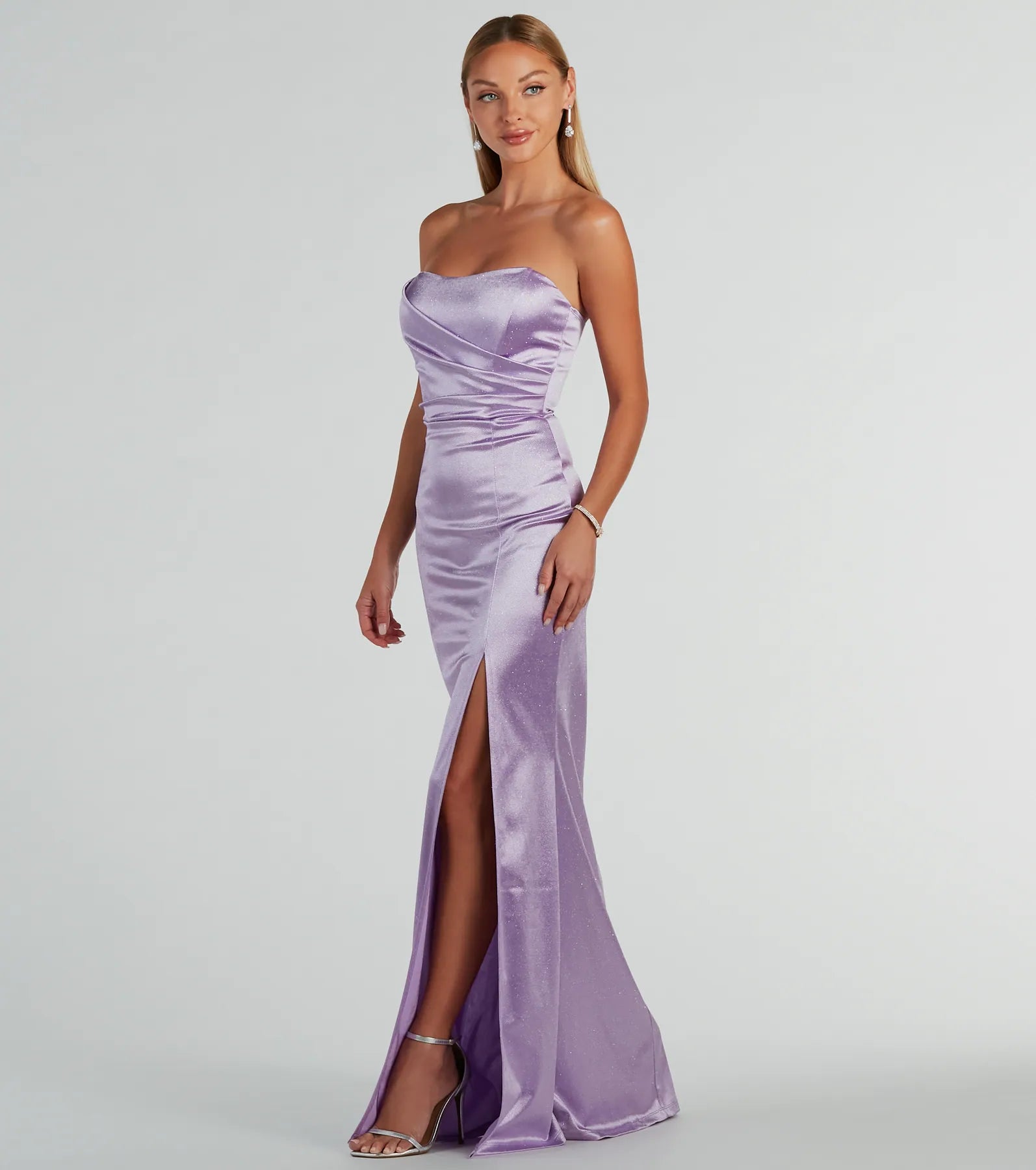 A stunning pick for an engagement photoshoot outfit or winter wedding guest dress, this glitter formal dress showcases the Aliyah Strapless Mermaid Satin Glitter Dress in lavender with a graceful silhouette that captures the moment.