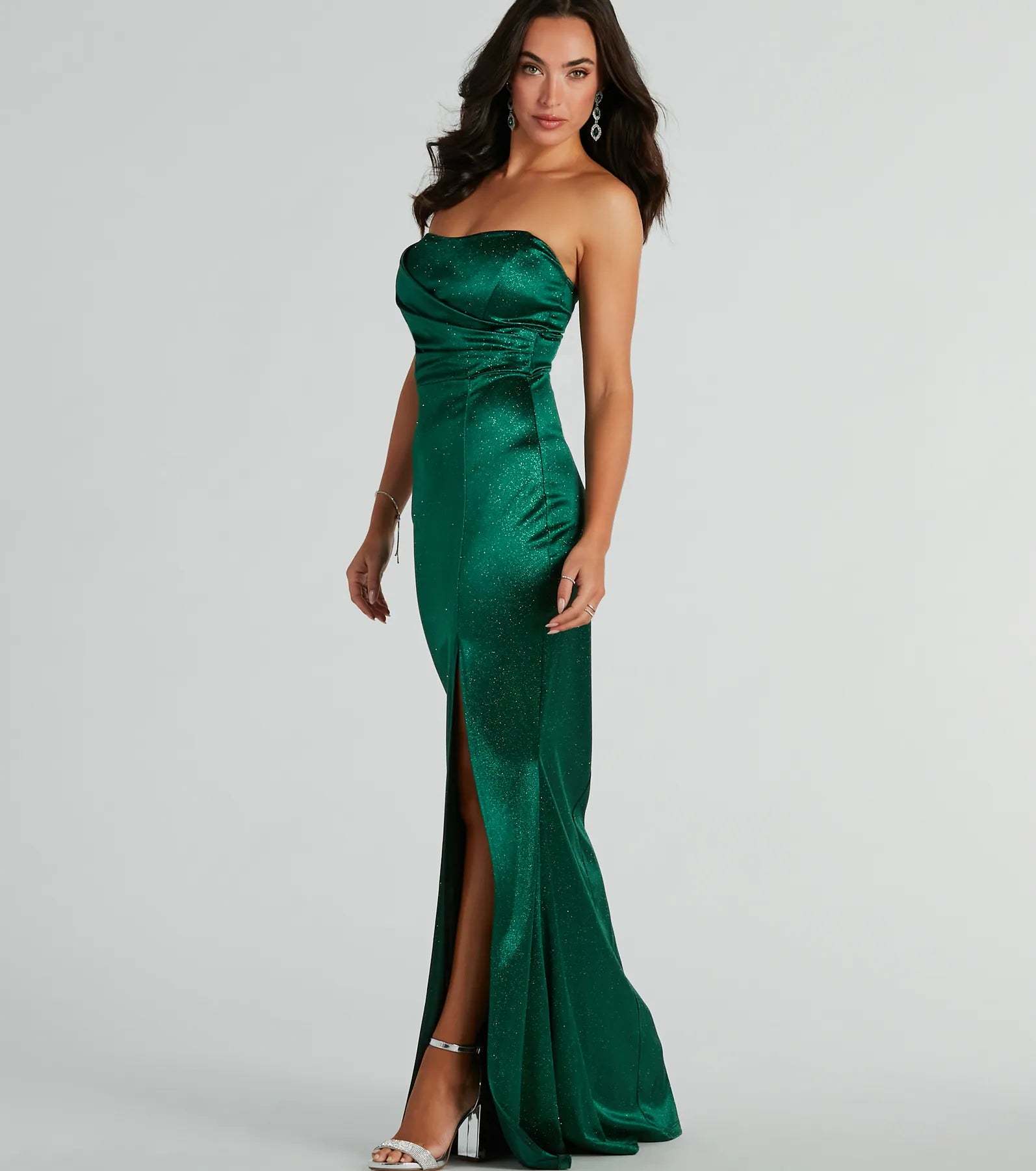 A stunning pick for an engagement photoshoot outfit or winter wedding guest dress, this glitter formal dress showcases the Aliyah Strapless Mermaid Satin Glitter Dress in hunter green with a graceful silhouette that captures the moment.