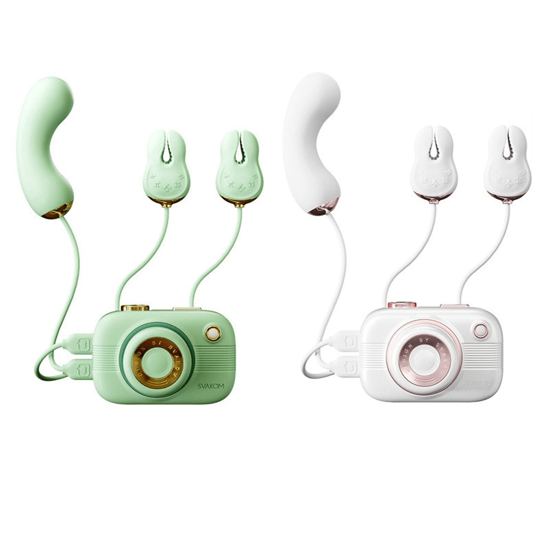 Camera-shaped vibrator with suction attachment on white background