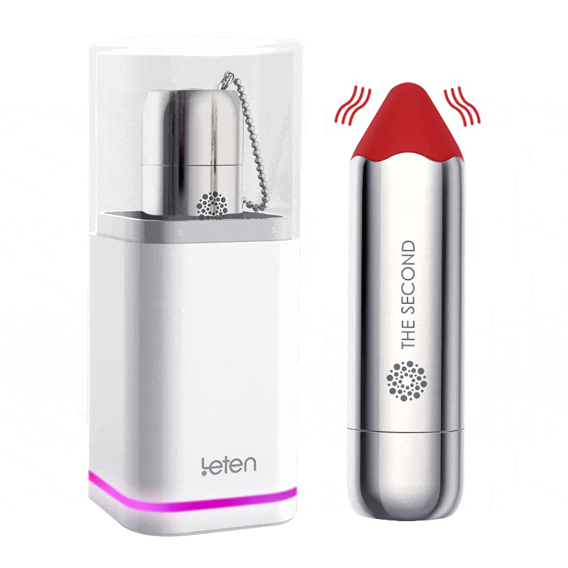 Compact lipstick vibrator with sleek silver design on charging dock