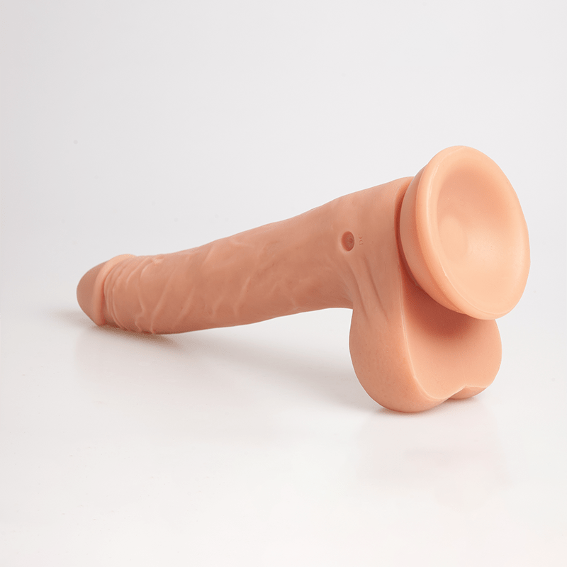 Telescopic dildo extended with wireless remote on white background