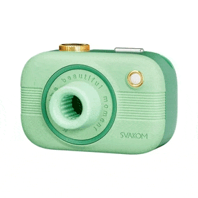 Camera-shaped vibrator with suction attachment on white background