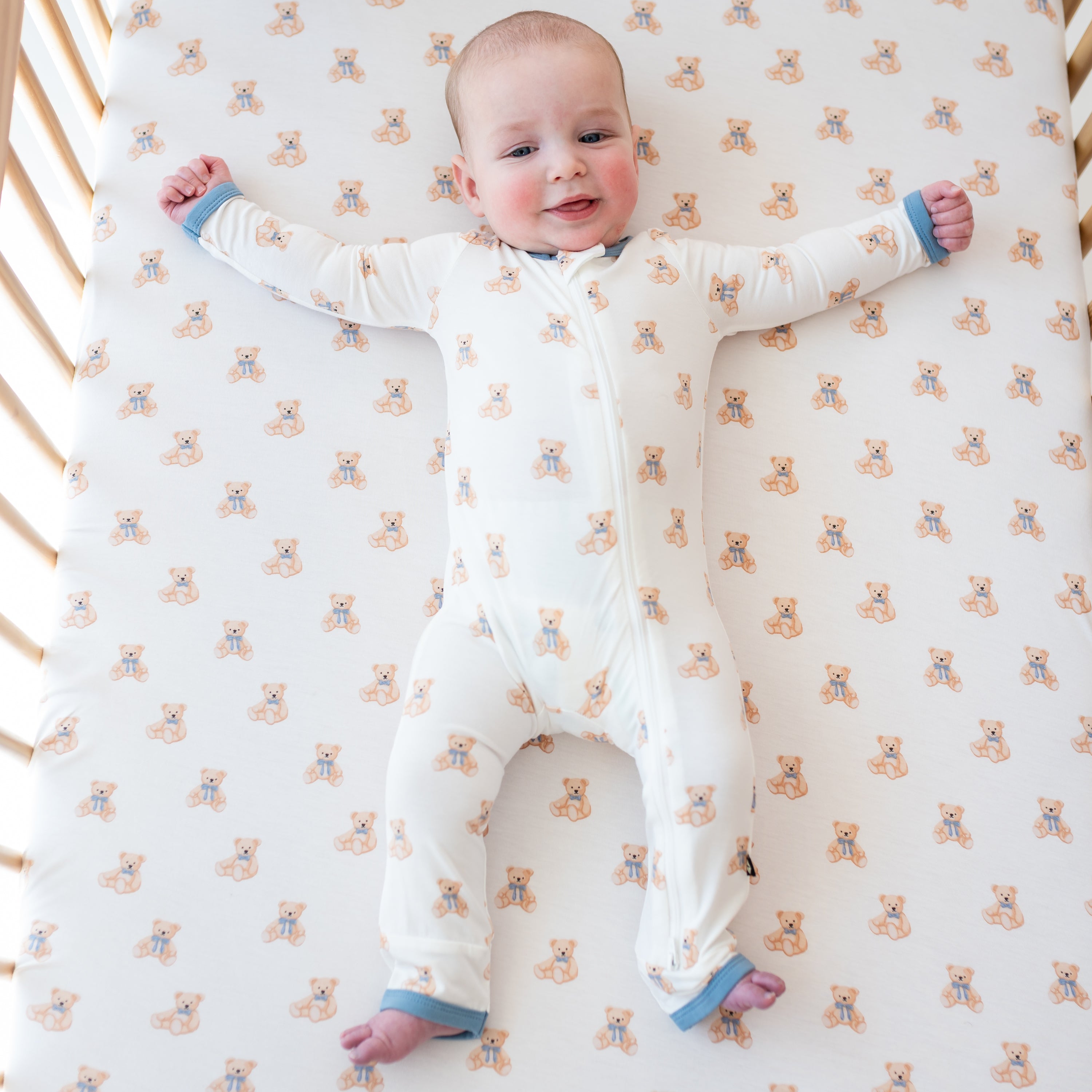 Baby wearing Zippered Romper in Teddy Bear in crib