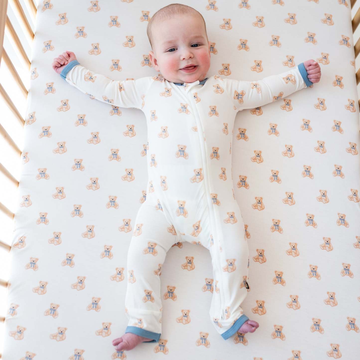 Baby wearing Zippered Romper in Teddy Bear in crib