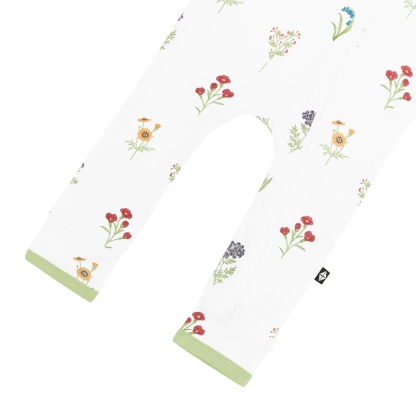 Zippered Romper in Wildflower close up on feet holes