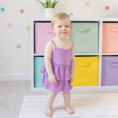 Toddler modeling Spaghetti Strap Ruffle Romper in Poi