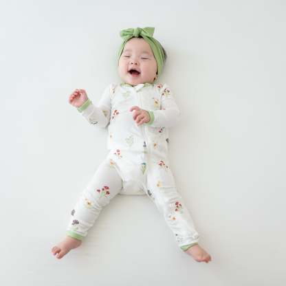Baby in Zippered Romper in Wildflower and Honu Headband Bow
