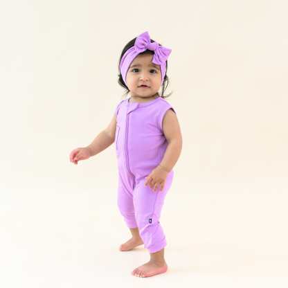 Toddler wearing Kyte Baby Sleeveless Zippered Romper with Dual Zipper in Poi