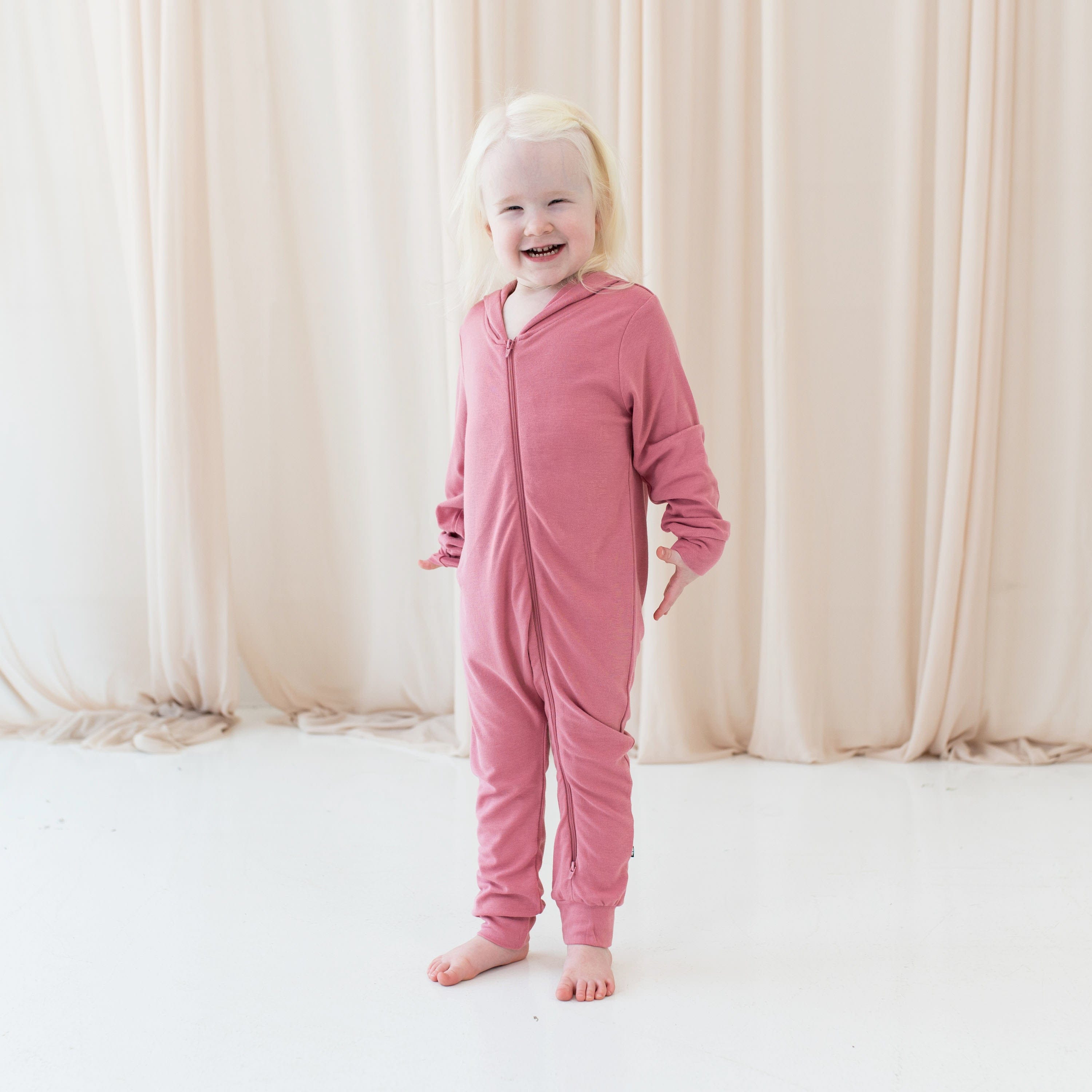 Girl wearing Bamboo Jersey Romper with Hood in Apple Blossom pink