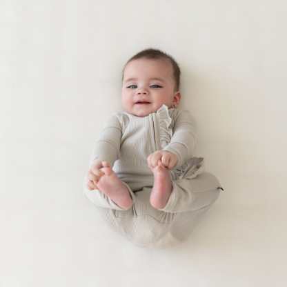 Kyte Baby Ribbed Ruffle Zipper Romper Ribbed Ruffle Zipper Romper in Oat