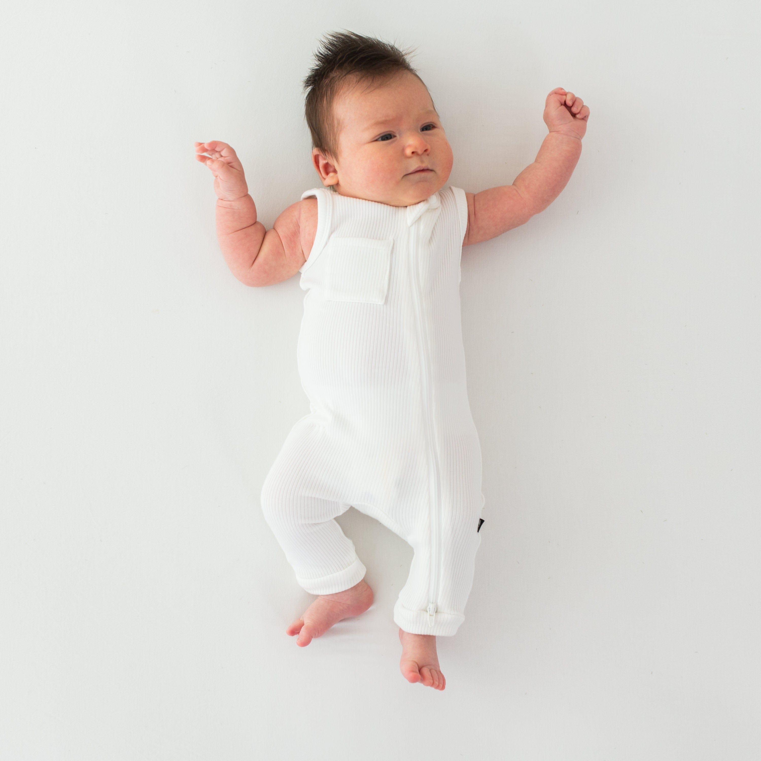 Newborn wearing Kyte Baby Sleeveless Ribbed Zippered Romper in Cloud