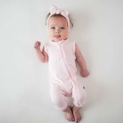 Infant wearing Kyte Baby Ribbed Zippered Sleeveless Romper in Sakura