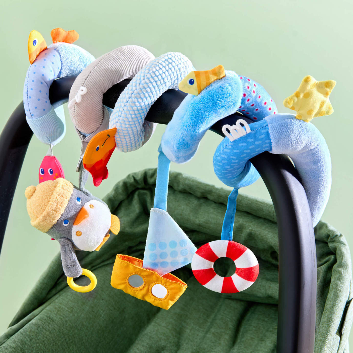 Penguin Activity Spiral Stroller & Car Seat Toy on a car seat.