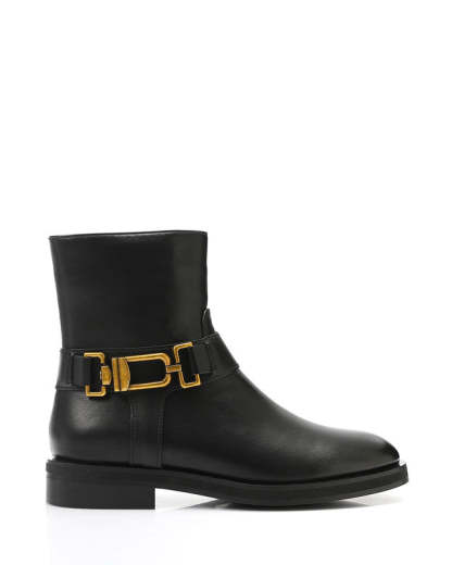 Black ankle boot with gold buckle on a white background