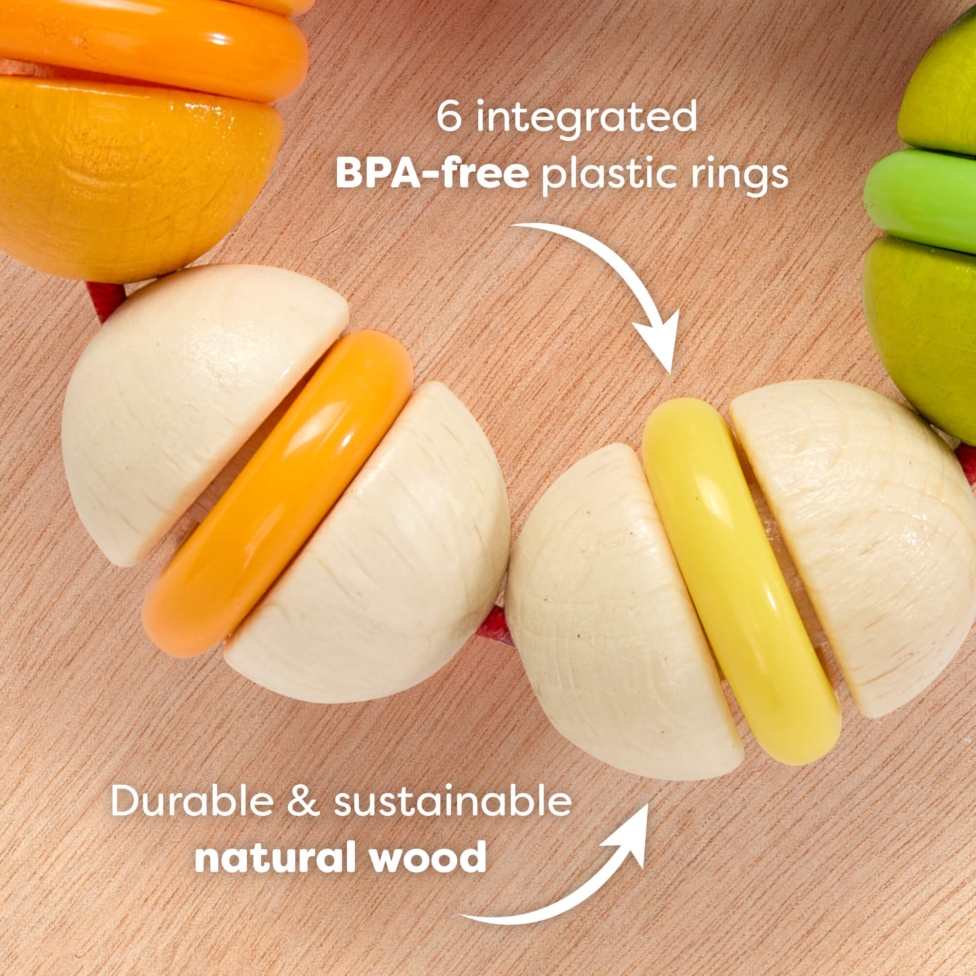 Rainbow Rattle Grasping and Teething Toy  on a wooden surface with text reading '6 integrated BPA-free plastic rings. Durable and sustainable natural wood'