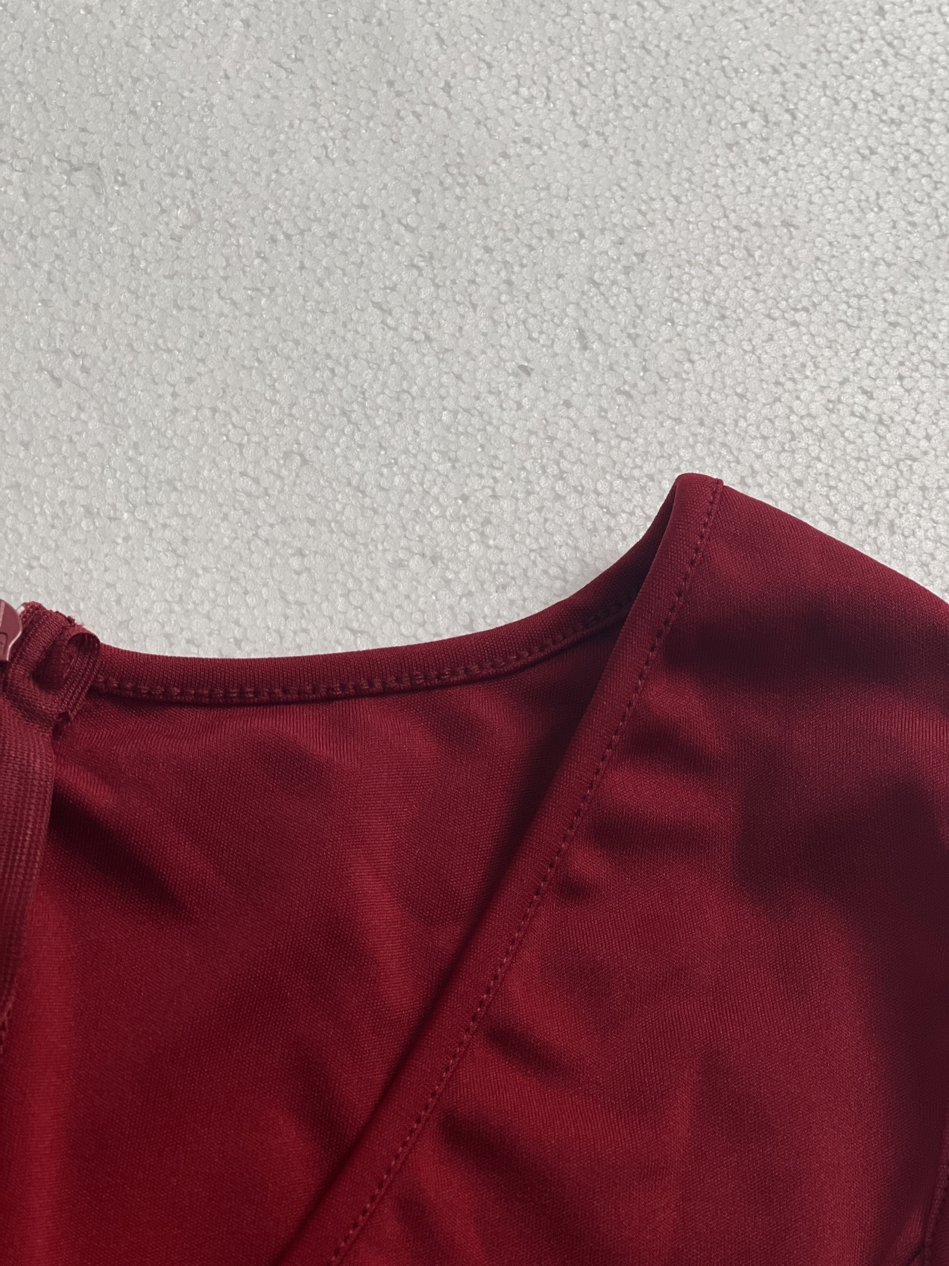 Woman's Red sleeveless two-piece suit with V-neck, frilly hem and wide legs.