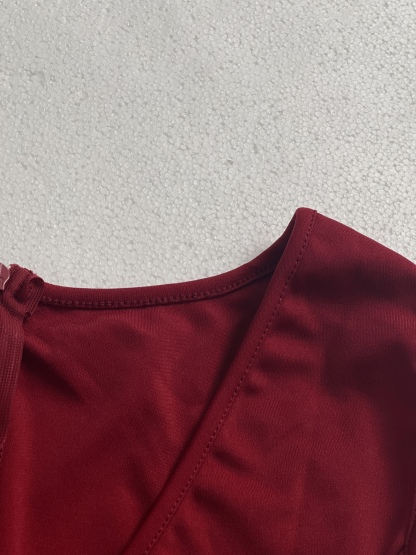 Woman's Red sleeveless two-piece suit with V-neck, frilly hem and wide legs.