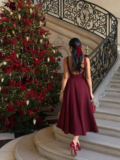 Wine-red boat-collared sleeveless mid-length skirt with flowing waist, a high-end banquet-style dress