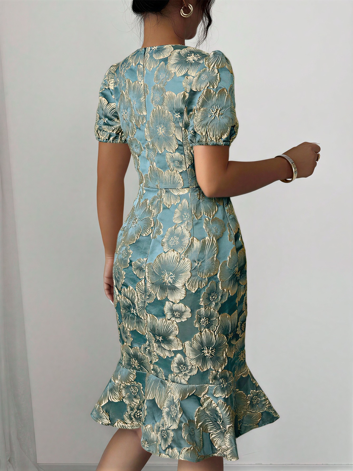 Women in flowered, bubble-sleeved, fish-tail dresses with waist-shrouding, hip-shrouding mid-skirts