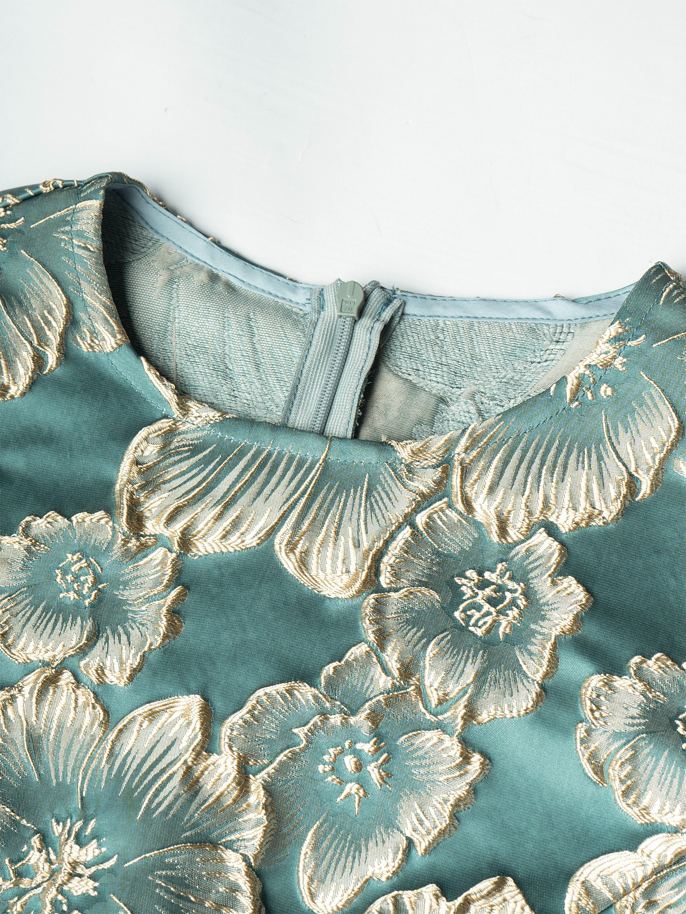 Women in flowered, bubble-sleeved, fish-tail dresses with waist-shrouding, hip-shrouding mid-skirts