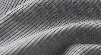 A MODEL POSES WEARING SKIMS SOFT LOUNGE