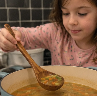 Child helping with soup preparation