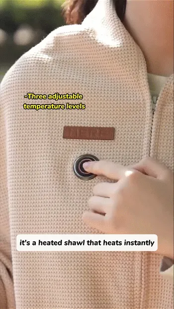 Person pressing the control button on a beige heated shawl