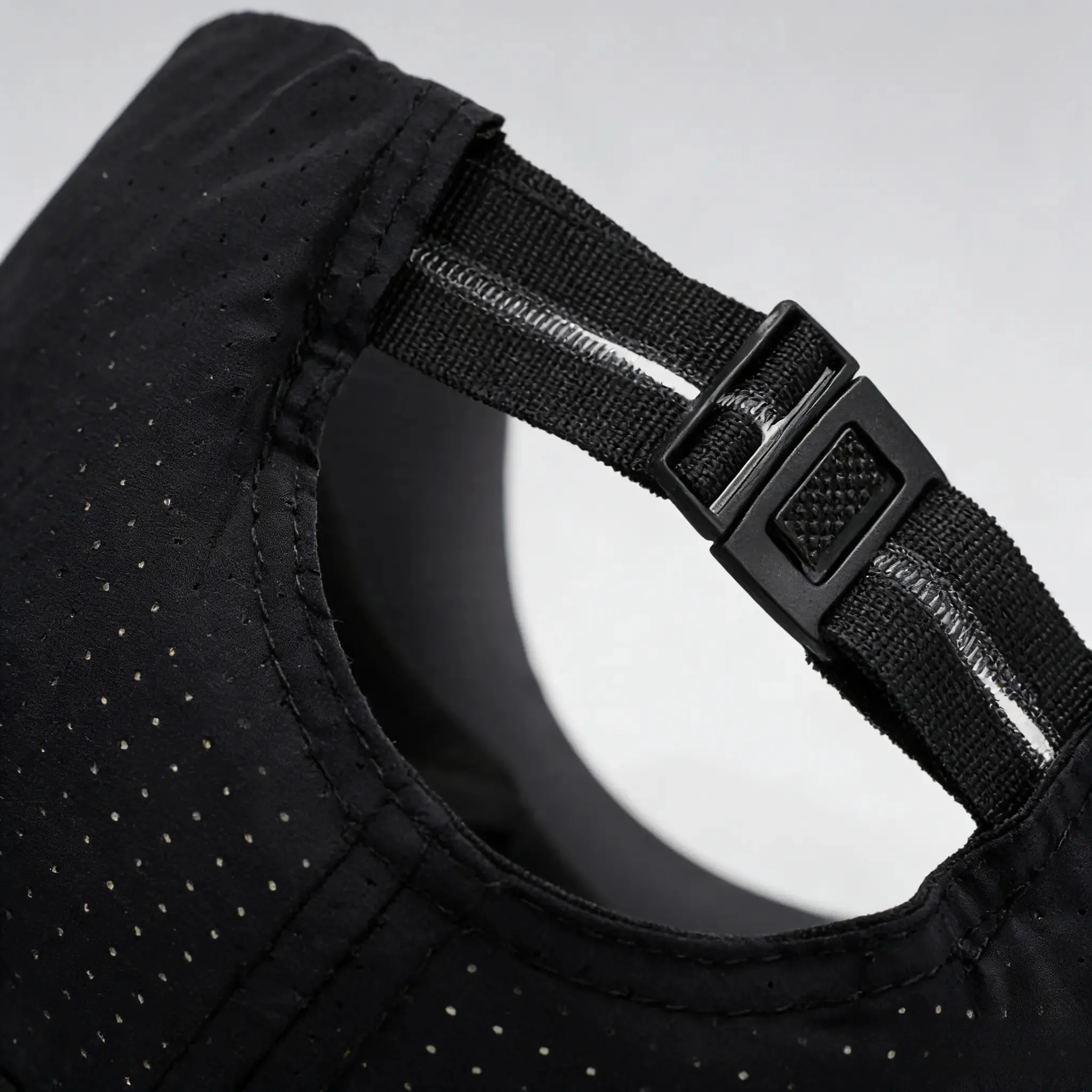 Close-up of adjustable rear strap on black cap