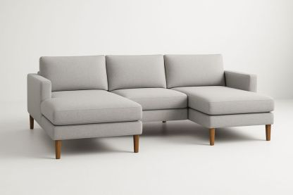 Szürke L-alakú sarokkanapé tömör fa lábakkal, szövet borítással