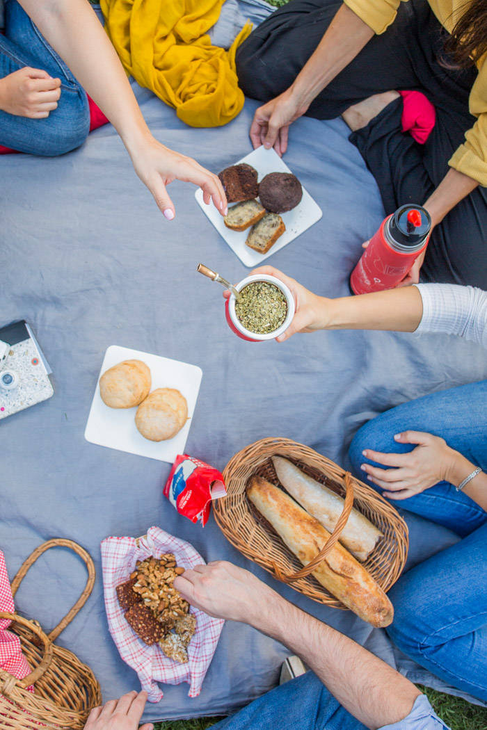 Friends sharing Yerba Mate tea in a traditional South American social setting