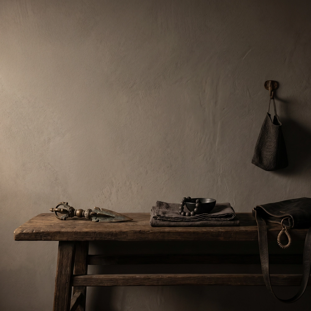 {"default":"Square mobile banner showing a Phurba-inspired object, beads, bowl, hanging bag, and leather strap in a quiet symbolic interior space."}
