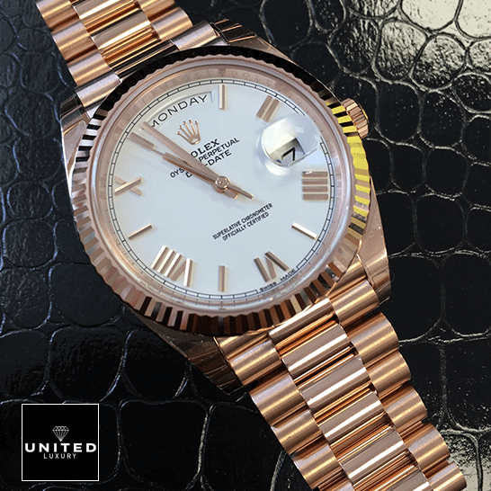 rolthtex Day-Date 228235 Rose Gold Replica on the black leather table
