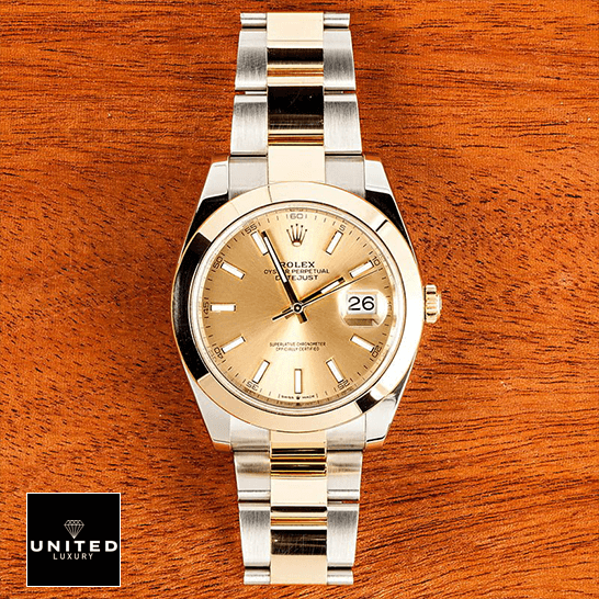 rolthtex Datejust 126303 Gold Dial Replica on a wooden table