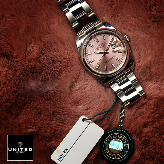 rolthtex Datejust 116200 Pink Dial Replica next to the quarantine card on soft ground