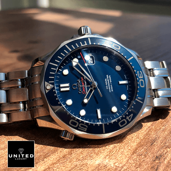 omethtga Seamaster 300m Axial Steel Replica on the wooden table