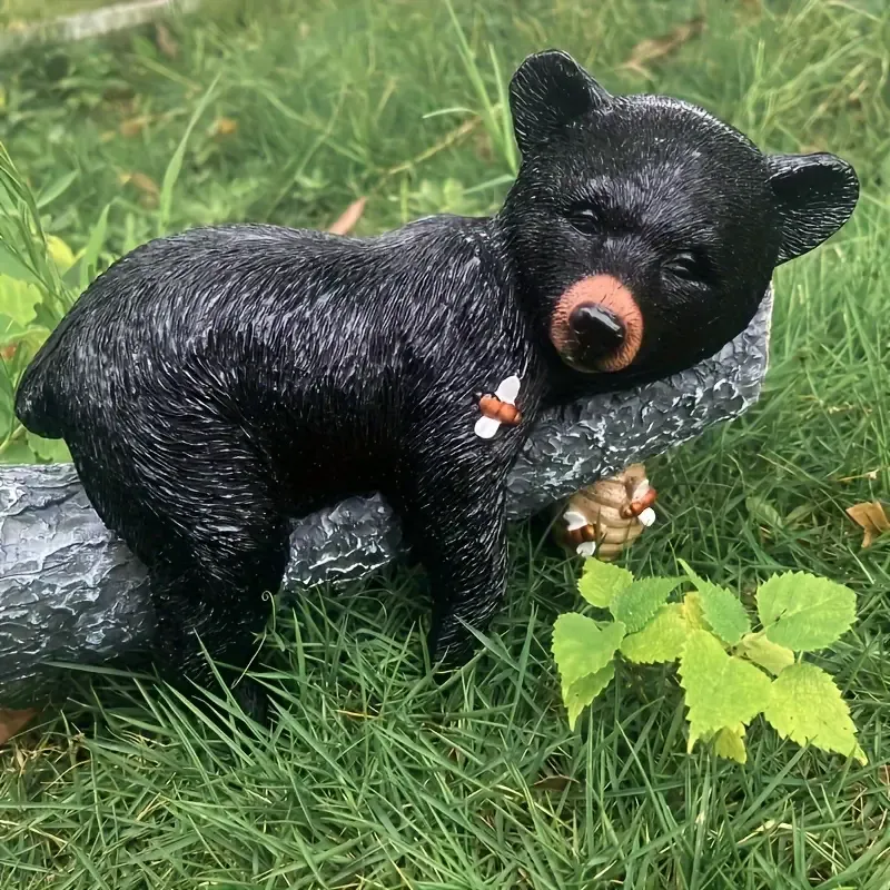 🐻Skulptur eines kleinen schwarzen Bären beim Honiggraben