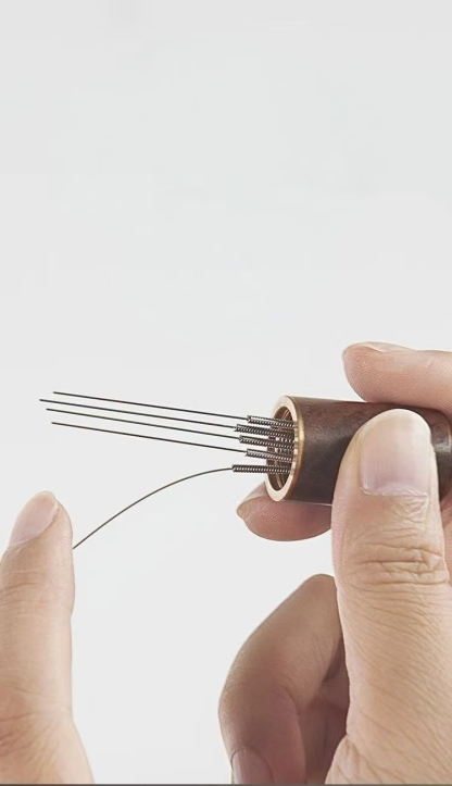 Coffee distribution needle and filter paper