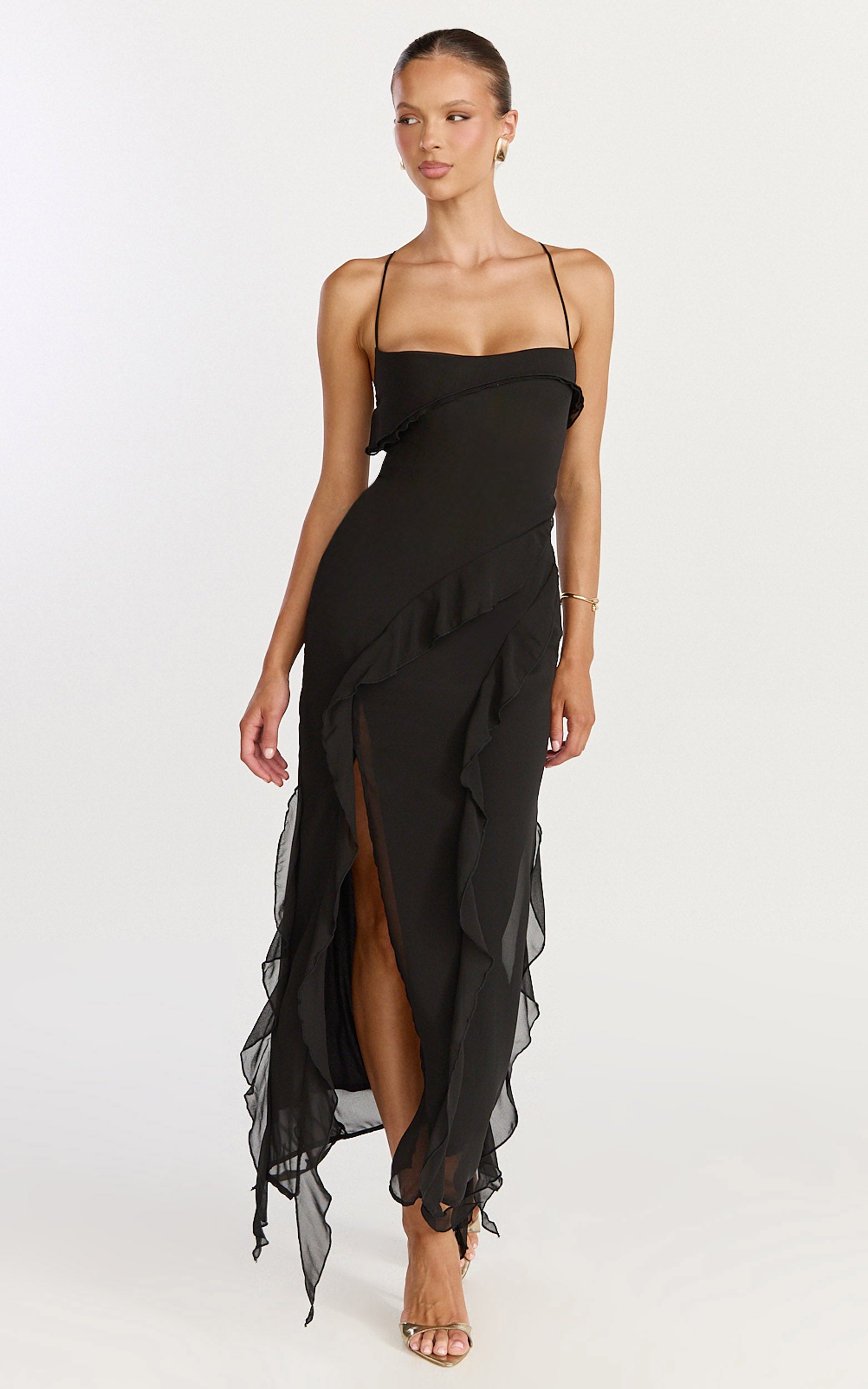 Model is wearing a ruffled midi dress in black.