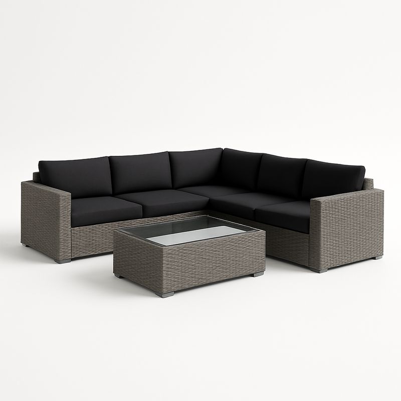 Divano angolare in rattan con cuscini neri e tavolino in vetro-Nestlivi