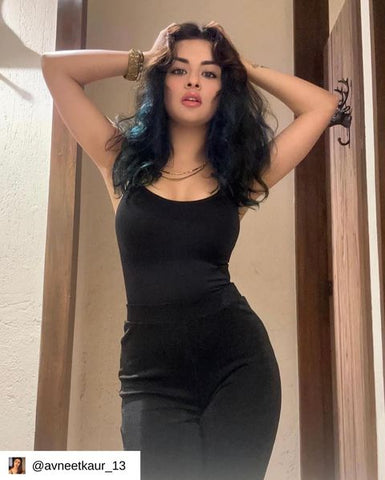 A woman confidently wearing the Snatched Bodysuit Bodyshaper, highlighting its shaping and fit.