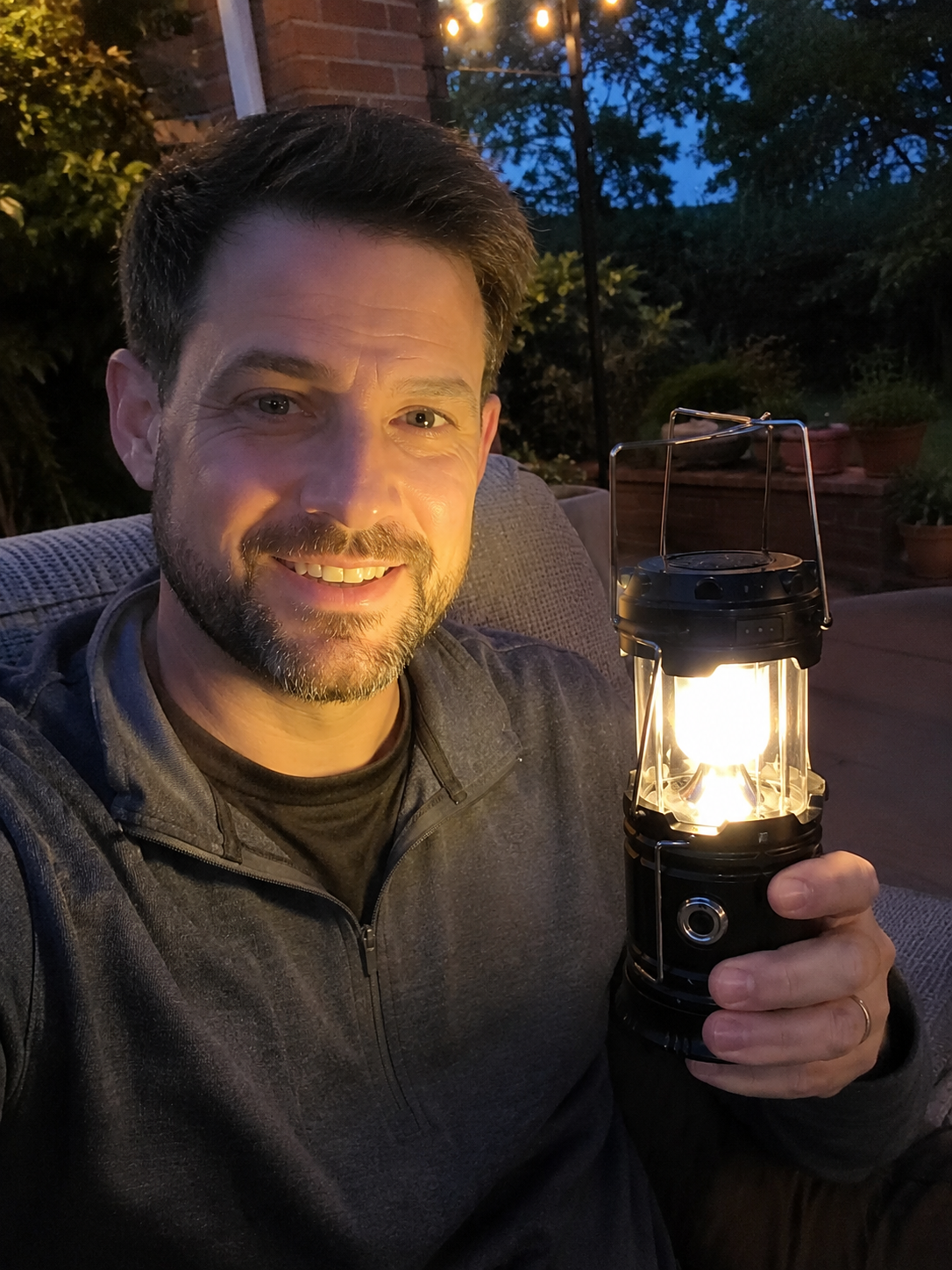 Image placeholder: happy customer holding the solar emergency camping light outdoors