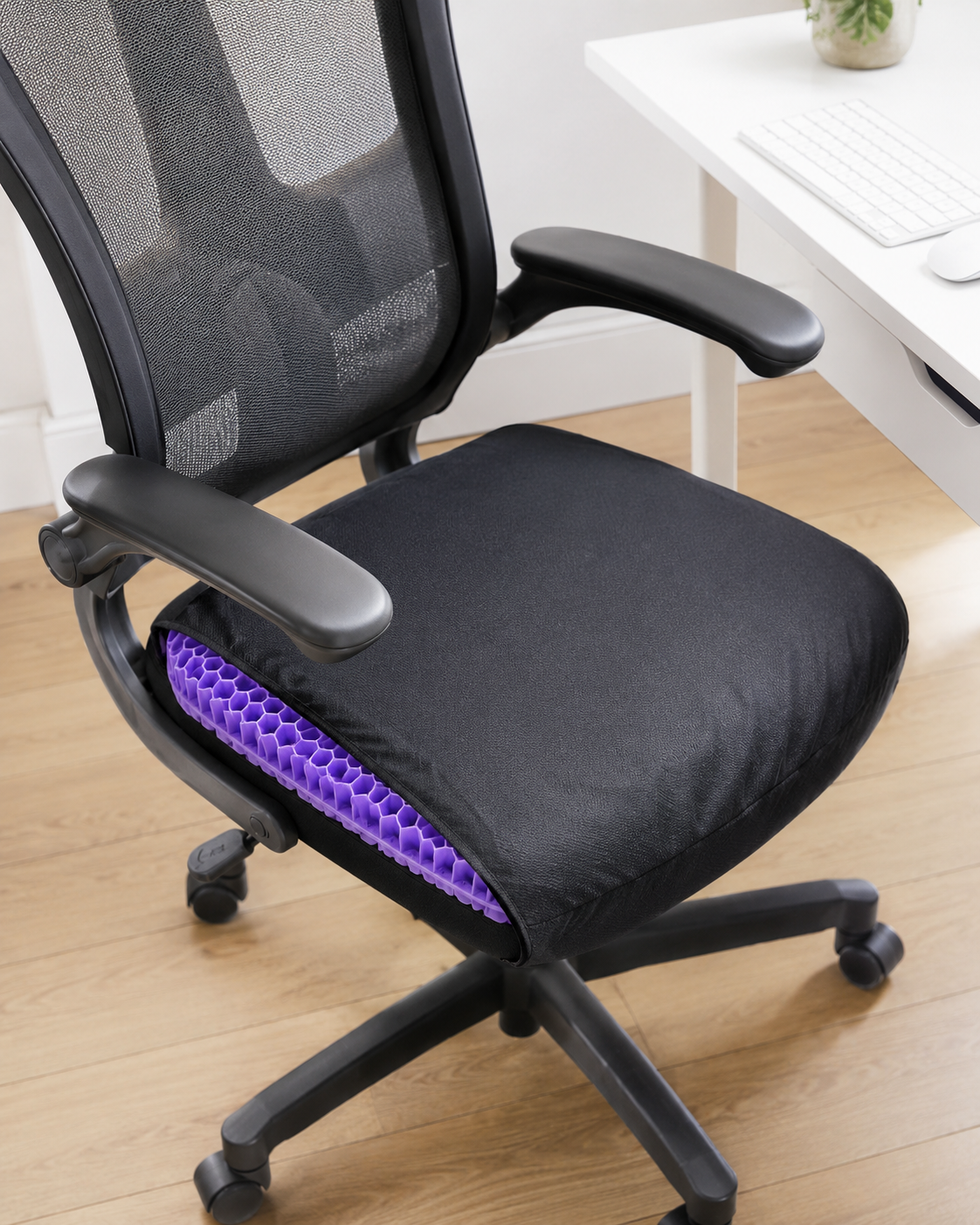 Black-covered purple silicone gel cushion placed on a modern office chair