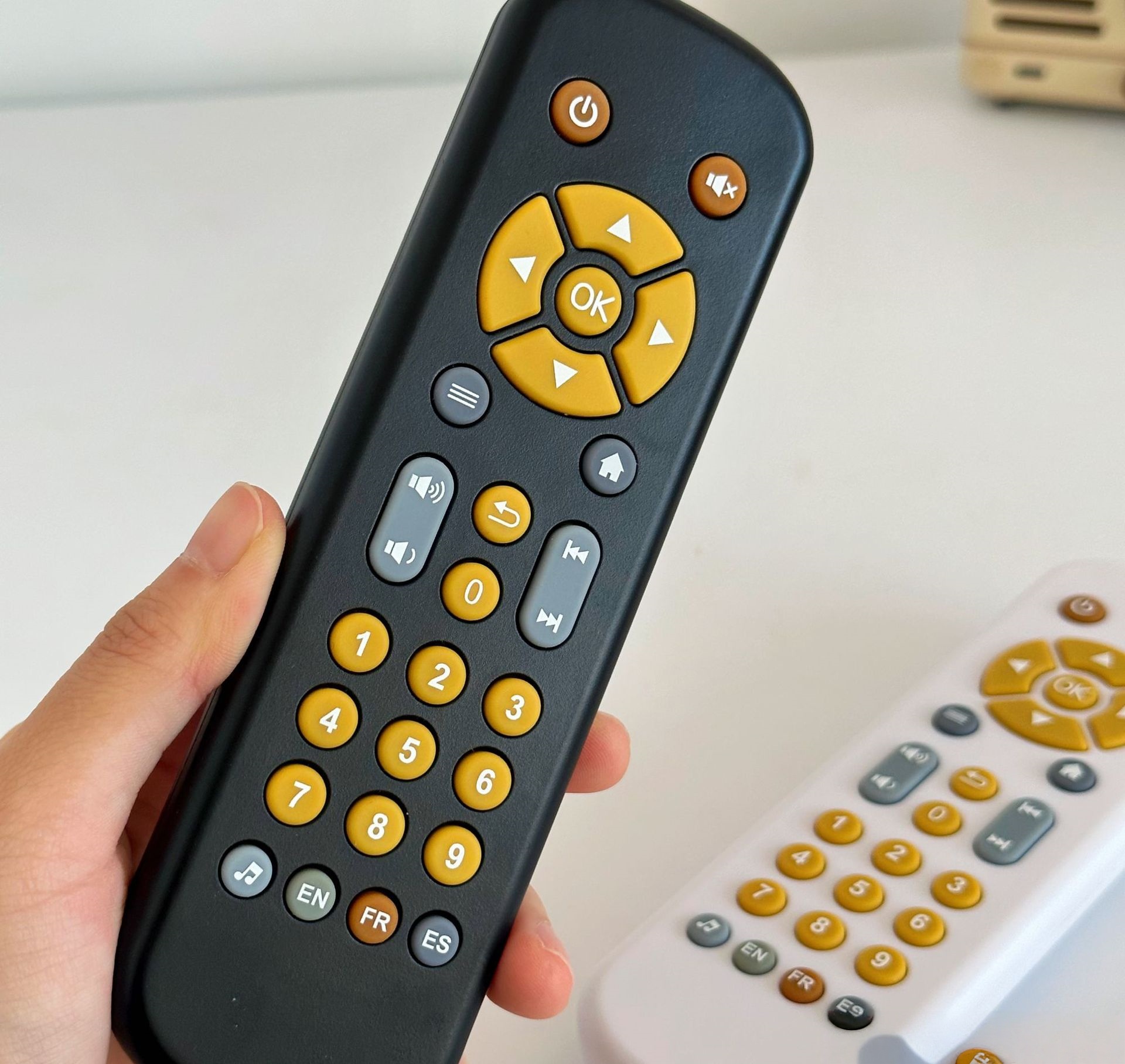 A simulated TV remote control that supports early childhood education in English, French, and Spanish