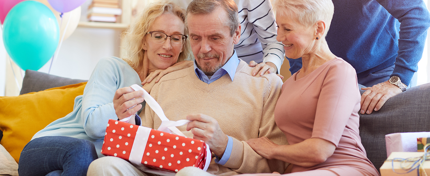 a man and woman looking at a present