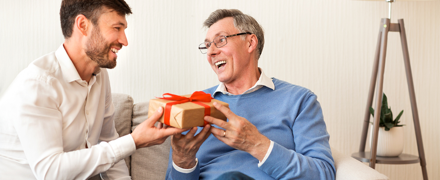 a man receiving a gift from a senior man
