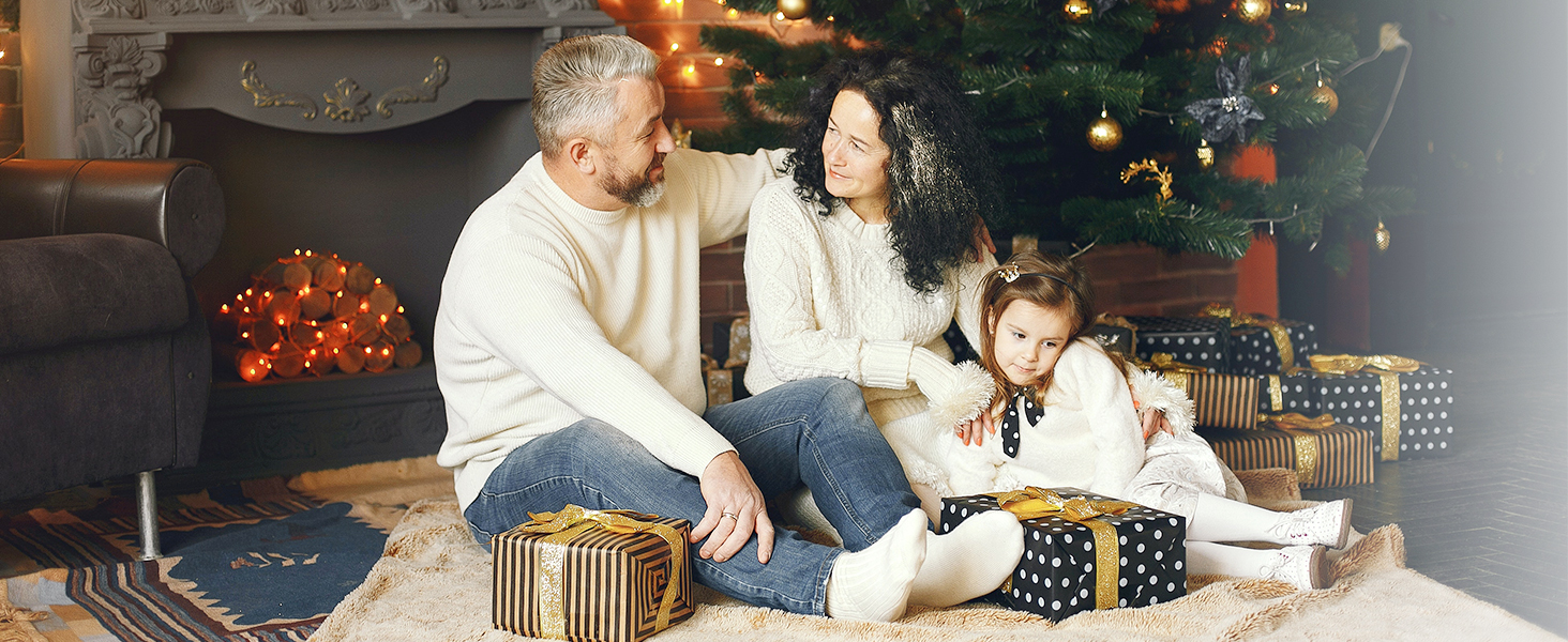family sitting by the fireplace