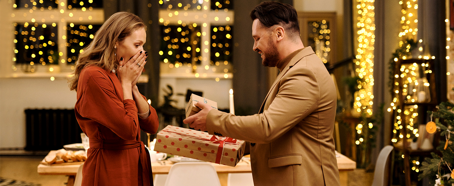 a man and a woman present a christmas present