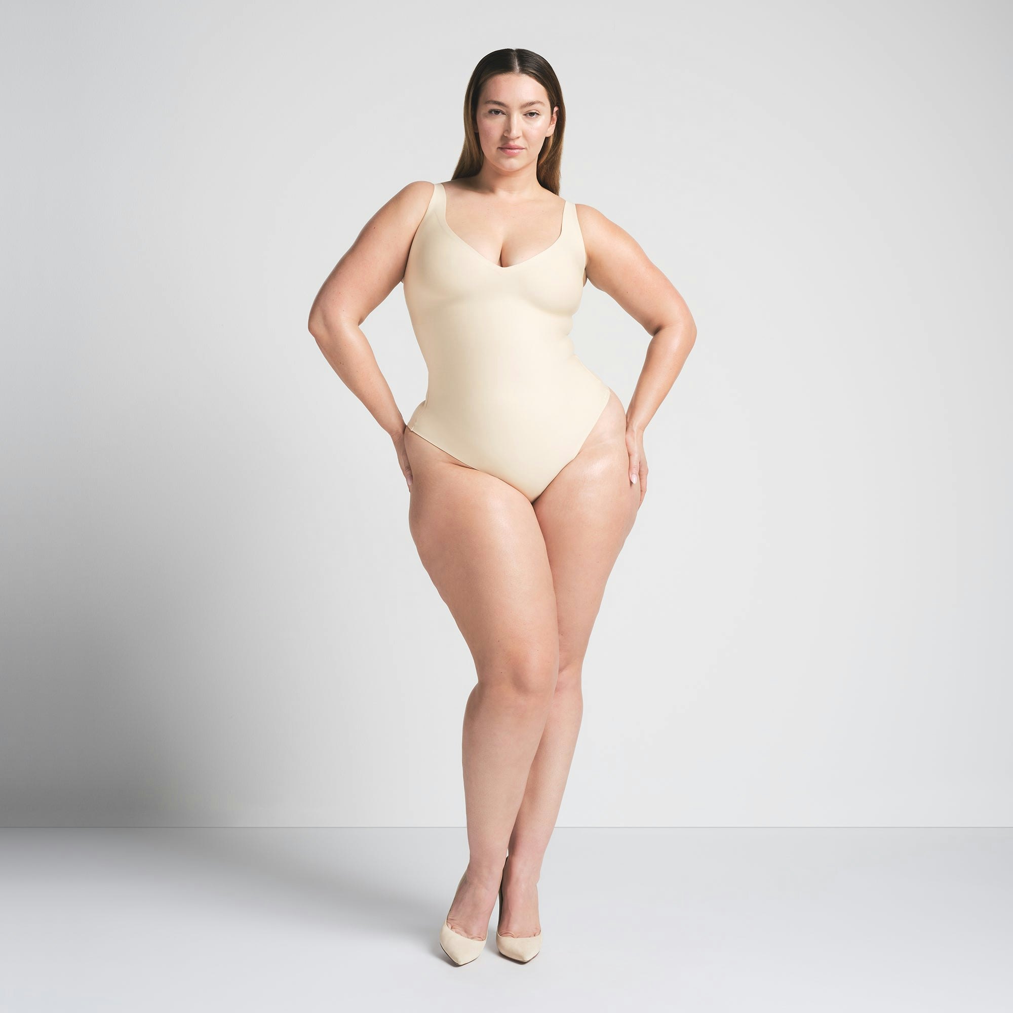 SKIMS BODY UNLINED PLUNGE THONG BODYSUIT - SAND